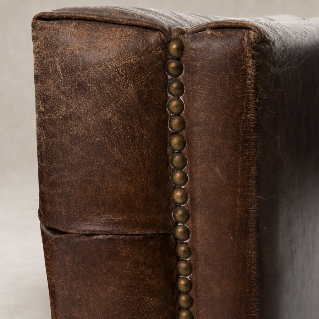 Venice Club Chair in Cigar featuring rich leather texture and decorative nail head trim.