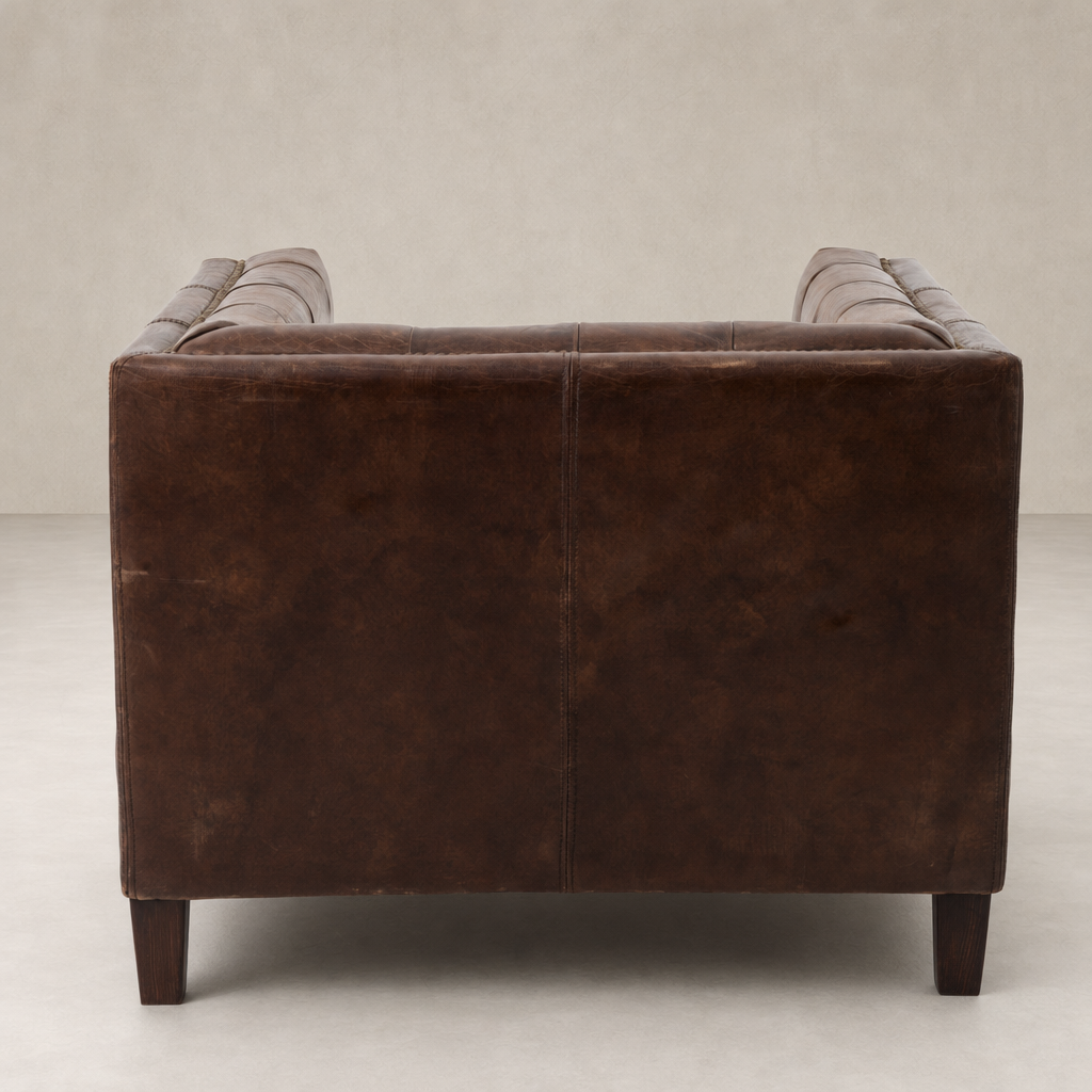 Venice Club Chair in Cigar leather showcasing sleek lines and sturdy wooden legs.