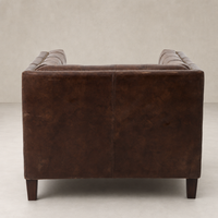 Venice Club Chair in Cigar leather showcasing sleek lines and sturdy wooden legs.