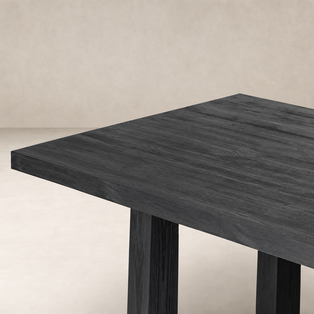 Landsbury Dining Table in black pine with a sleek, modern design and sturdy legs.