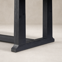 Close-up of the Landsbury Dining Table's black pine legs and base design.