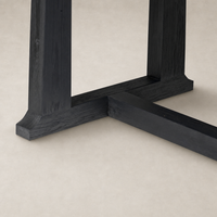 Landsbury Dining Table with a sleek black pine base and detailed corner accents.