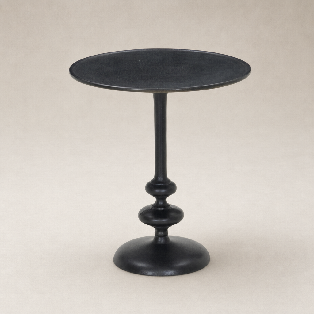 Calder Matchstick Pedestal Table features a sleek black finish and elegant rounded base.