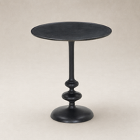 Calder Matchstick Pedestal Table features a sleek black finish and elegant rounded base.