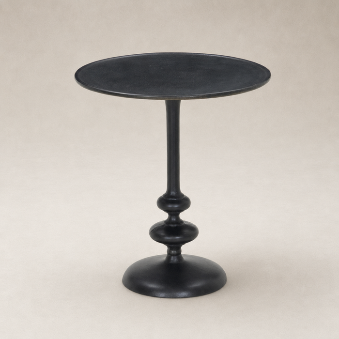 Calder Matchstick Pedestal Table features a sleek black finish and elegant rounded base.