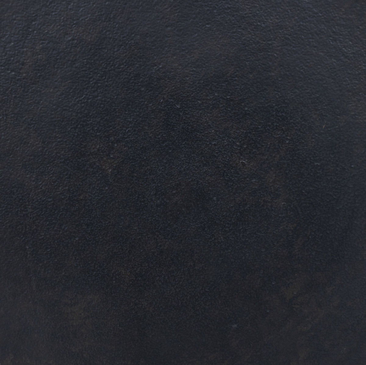 Calder Matchstick Pedestal Table surface showcasing rich dark texture and unique finish.