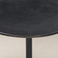 Calder Matchstick Pedestal Table with a sleek black round top and sturdy base.