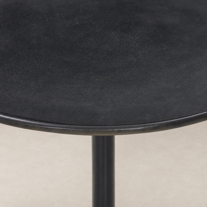 Calder Matchstick Pedestal Table with a sleek black round top and sturdy base.