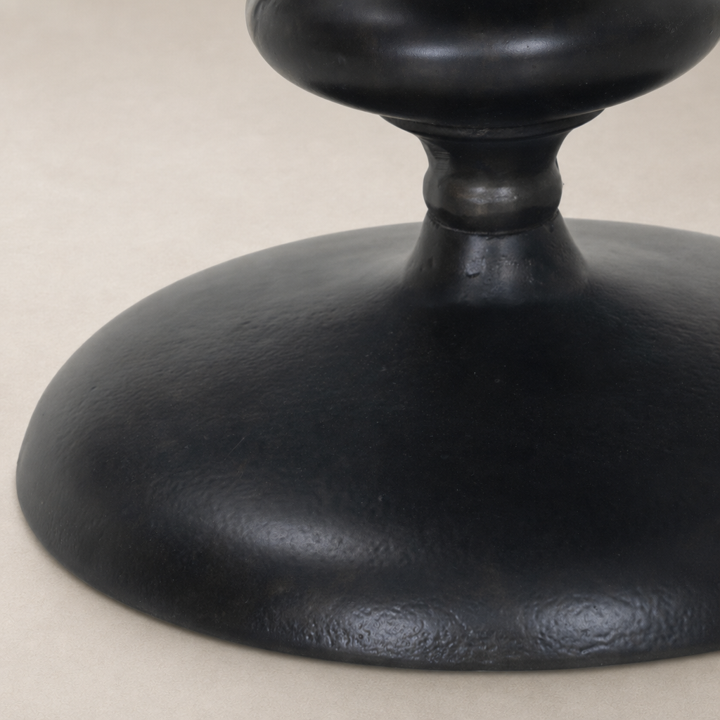 Close-up of the Calder Matchstick Pedestal Table's sleek, textured black base.