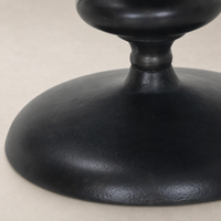 Close-up of the Calder Matchstick Pedestal Table's sleek, textured black base.