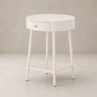 Finn Nightstand in soft white with a round top and gold drawer knob.