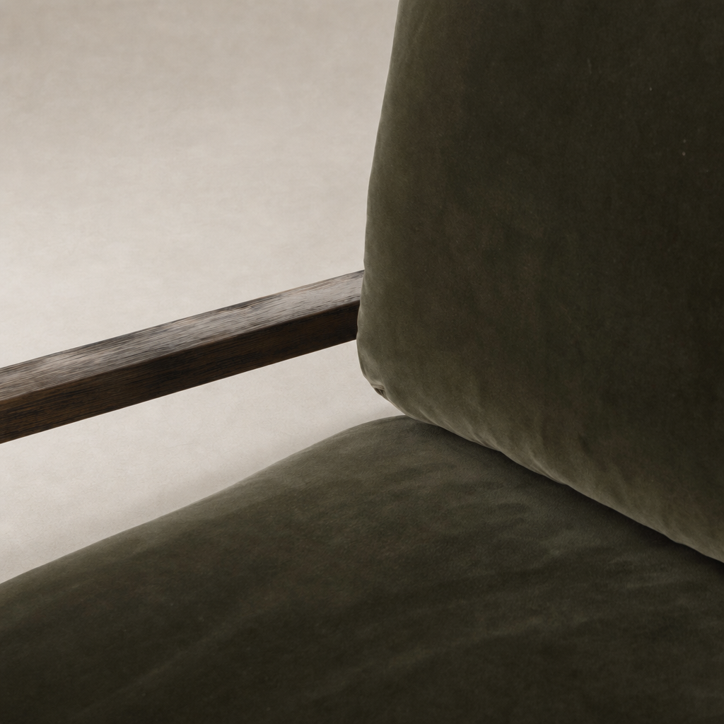 Surrey Olive Sawyer Chair featuring soft upholstery and a natural wood armrest.