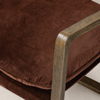 Sawyer Chair in Surrey Auburn with a plush, textured fabric and sleek wooden armrests.