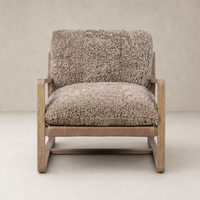 Taupe shearling Sawyer Chair with plush cushioning and wooden frame for cozy seating.