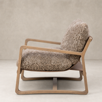 Taupe shearling Sawyer Chair with a sleek wooden frame and plush cushioning.