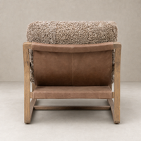 Back view of the Sawyer Chair in taupe shearling with a wooden frame.