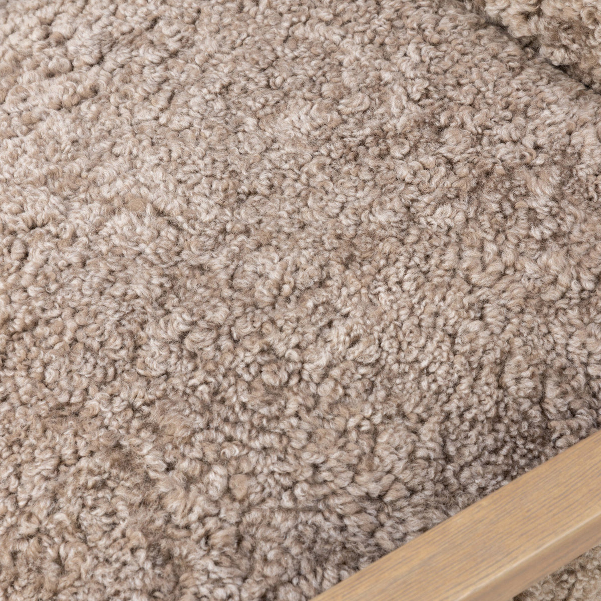 Close-up of taupe shearling upholstery on the Sawyer Chair, showcasing its soft texture.