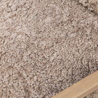 Close-up of taupe shearling upholstery on the Sawyer Chair, showcasing its soft texture.