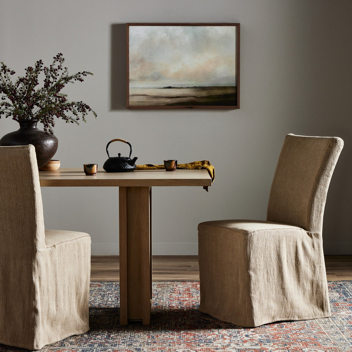Sierra Slipcovered Dining Chair in Broadway Canvas with elegant, loose-fit design at a dining table.