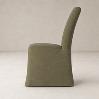 Sierra Slipcovered Dining Chair in Broadway Olive with a sleek, modern silhouette.