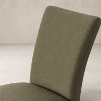 Sierra Slipcovered Dining Chair in Broadway Olive with a sleek, modern silhouette.
