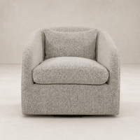 Magnolia Swivel Chair in Knoll Domino fabric features a cozy, curved design with plush cushions.