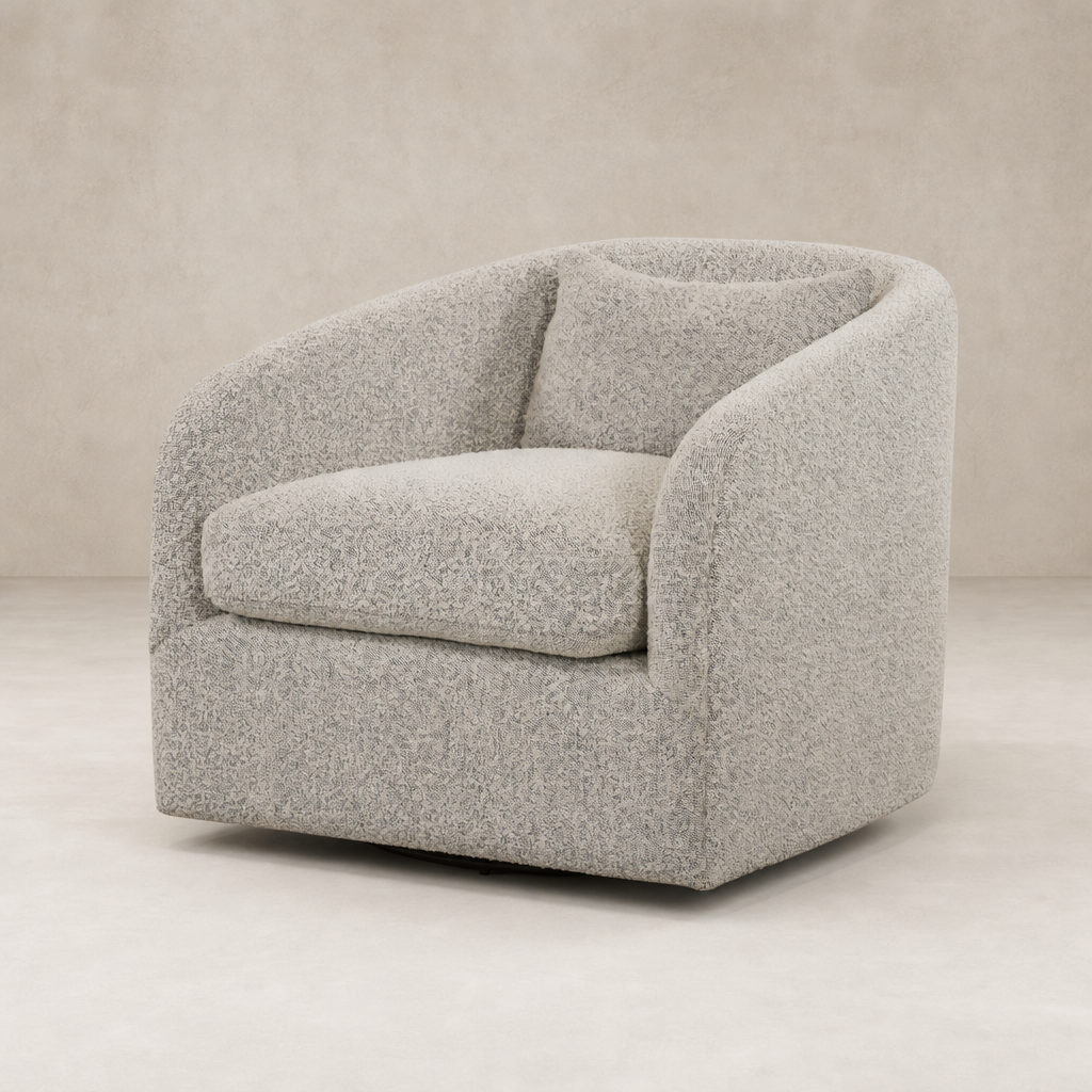 Magnolia Swivel Chair in Knoll Domino features a rounded design and plush cushions.