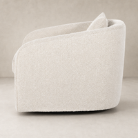 Magnolia Swivel Chair in Knoll Natural features a cozy, rounded design and soft texture.