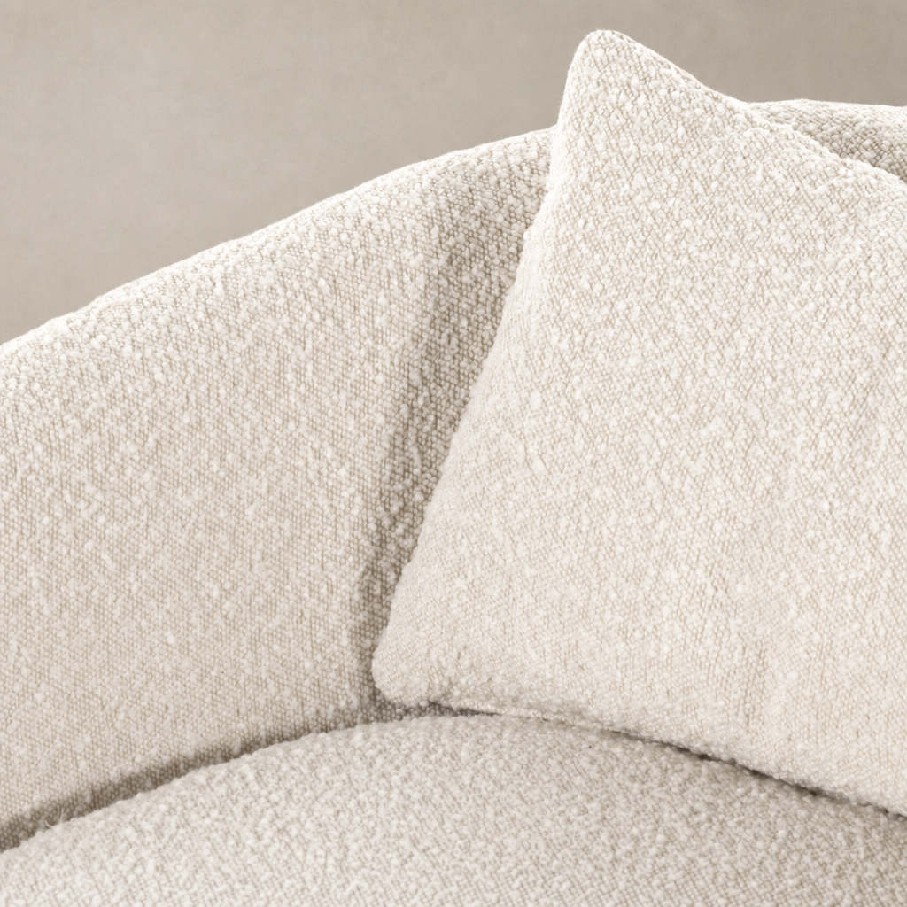 Close-up of Magnolia Swivel Chair in Knoll Natural showcasing soft, textured upholstery and cushion.