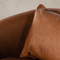 Close-up of Magnolia Swivel Chair in Heirloom Sienna, showcasing soft leather texture and cushion.