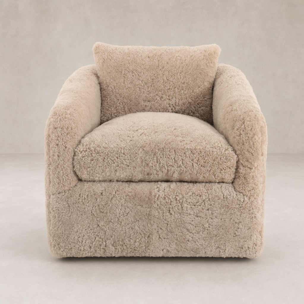 Magnolia Swivel Chair in soft beige shearling with plush cushions and rounded arms.