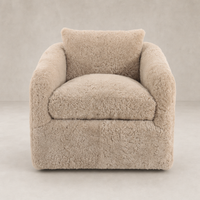 Magnolia Swivel Chair in soft beige shearling with plush cushions and rounded arms.