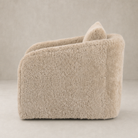 Beige shearling Magnolia Swivel Chair featuring a soft, rounded design and cozy texture.