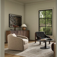 Beige shearling Magnolia swivel chair in a modern living room setting.