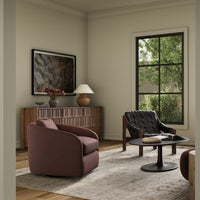 Magnolia Swivel Chair in Laughlin Plum, featuring a sleek, curved design in a stylish living room.