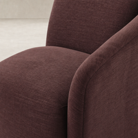 Magnolia Swivel Chair in Laughlin Plum featuring soft, textured upholstery and rounded arms.