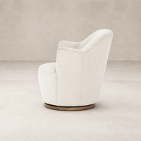 Soliel Swivel Chair in Knoll Natural upholstery with a curved silhouette and wooden base.