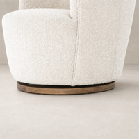 Soliel Swivel Chair in Knoll Natural featuring a textured upholstery and smooth wooden base.