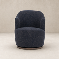 Soliel Swivel Chair in Thames Slate with a rounded design and soft upholstery.