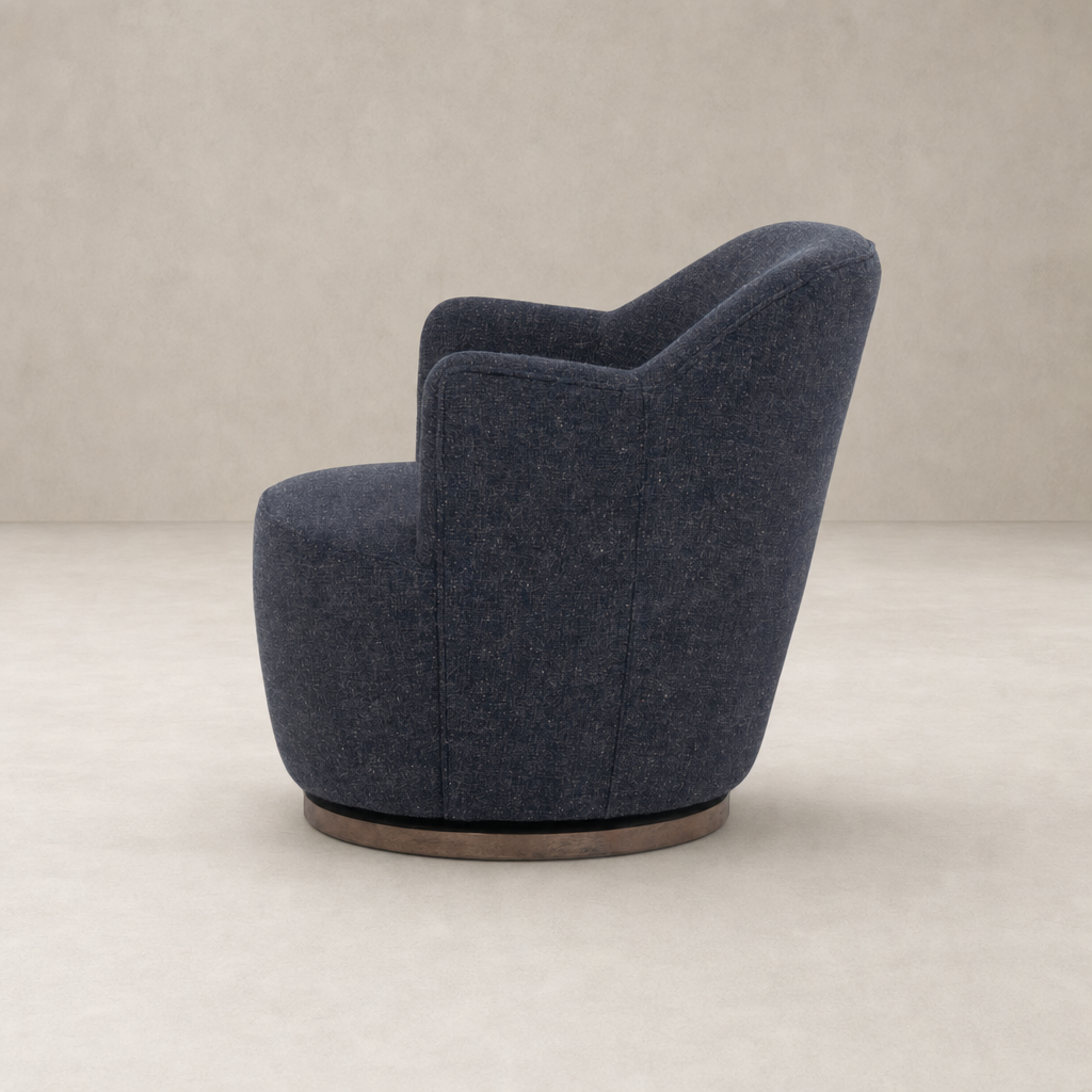 Soliel Swivel Chair in Thames Slate with plush upholstery and curved backrest design.