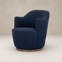 Copenhagen Indigo Soliel Swivel Chair with plush upholstery and round wooden base.