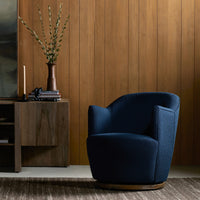 Soliel Swivel Chair in Copenhagen Indigo featuring a modern, curved design and textured upholstery.