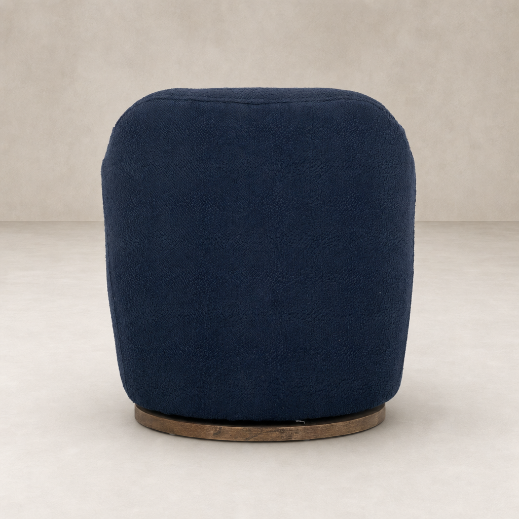 Soliel Swivel Chair in Copenhagen Indigo with a textured fabric finish and rounded shape.