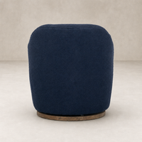 Soliel Swivel Chair in Copenhagen Indigo with a textured fabric finish and rounded shape.