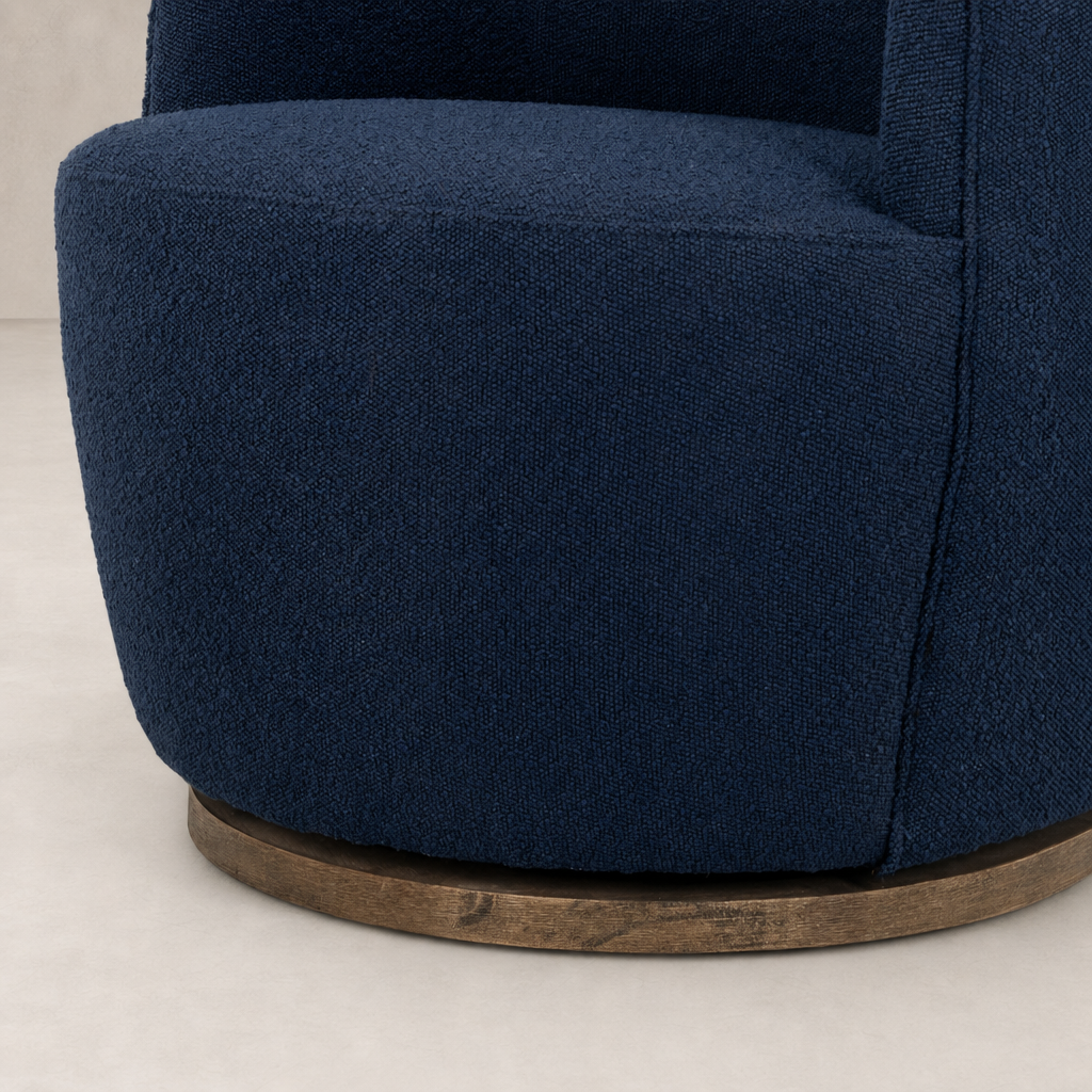 Copenhagen Indigo Soliel Swivel Chair with textured fabric and wood base.