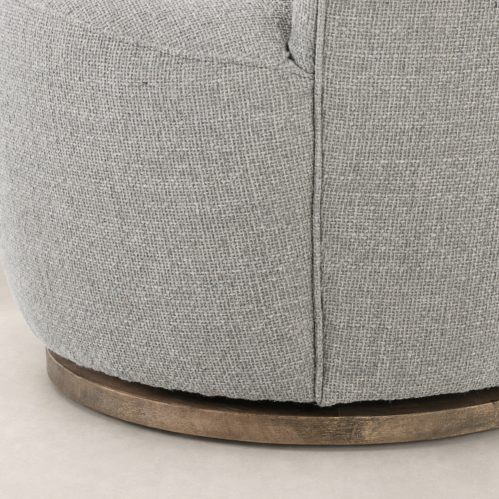 Close-up of the textured Gibson Silver fabric on the Soliel Swivel Chair's base.