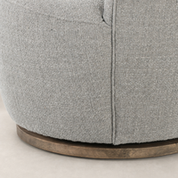 Close-up of the textured Gibson Silver fabric on the Soliel Swivel Chair's base.