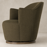 Soliel Swivel Chair in Fiqa Boucle Olive with a curved design and wooden base.