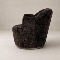 Cocoa shearling Soliel swivel chair with a plush, rounded design and soft texture.
