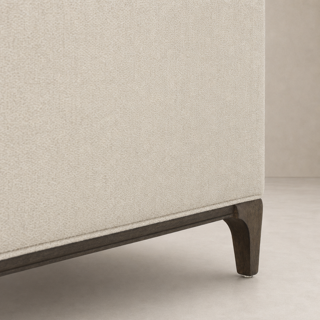 Close-up of Murano Chair in Kerbey Taupe, showcasing textured fabric and wooden legs.